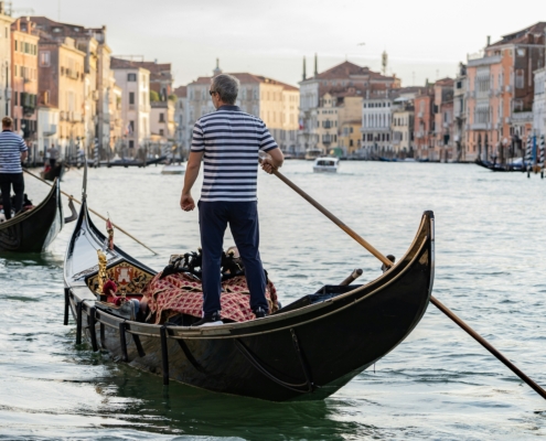 Gondolas floating along the Grand Canal in Venice, Italy, a popular stop on multi-country European trips