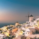 Whitewashed buildings and blue-domed churches overlooking the Aegean Sea in Santorini, Greece, a stunning stop on multi-country European trips